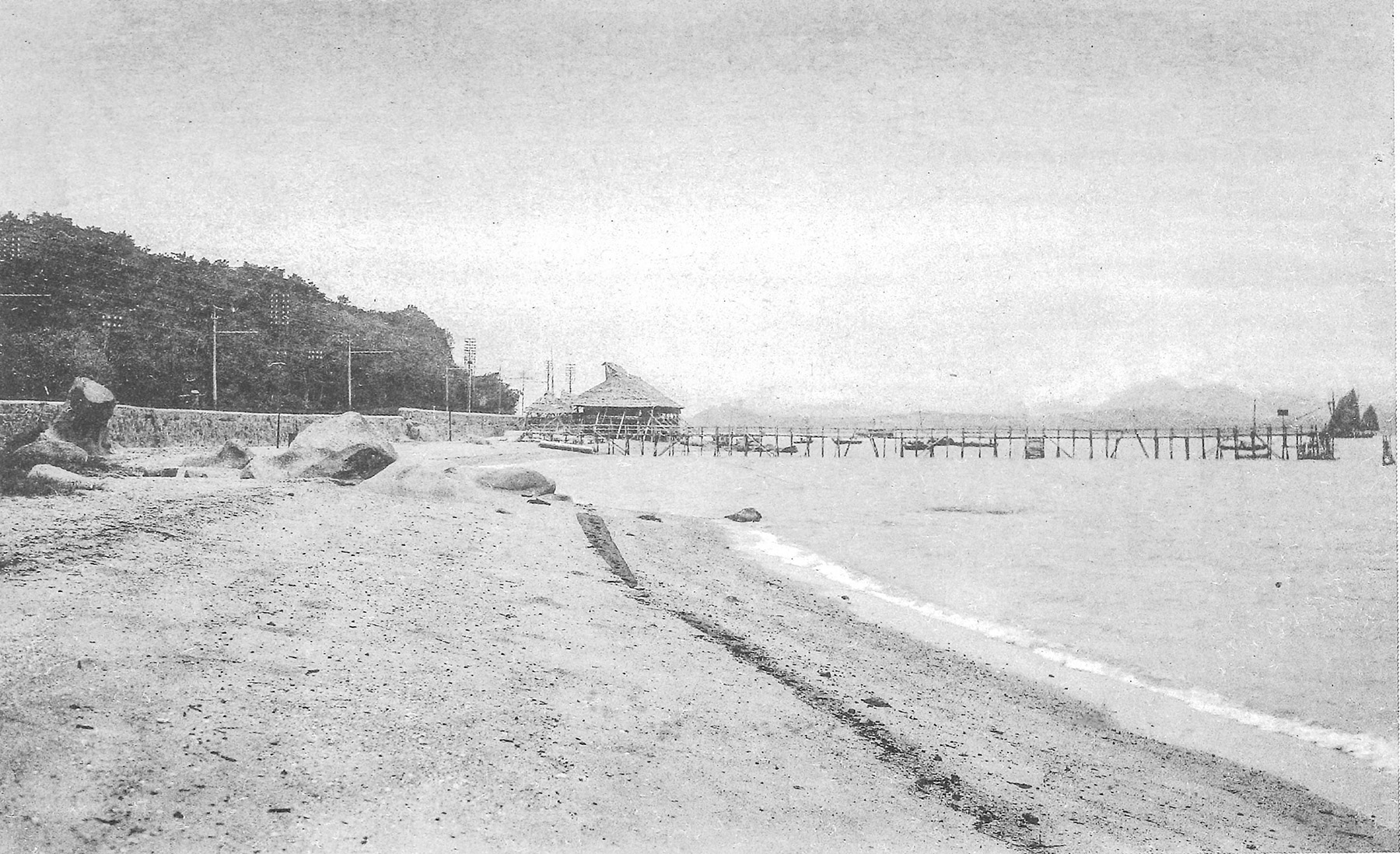 昔日的電車路幾乎等同海岸線；圖為約1920年七姊妹區附近的泳灘，旁邊的筲箕灣道（現時為英皇道）可見許多電車使用的電線桿。（鄭寶鴻提供圖片）